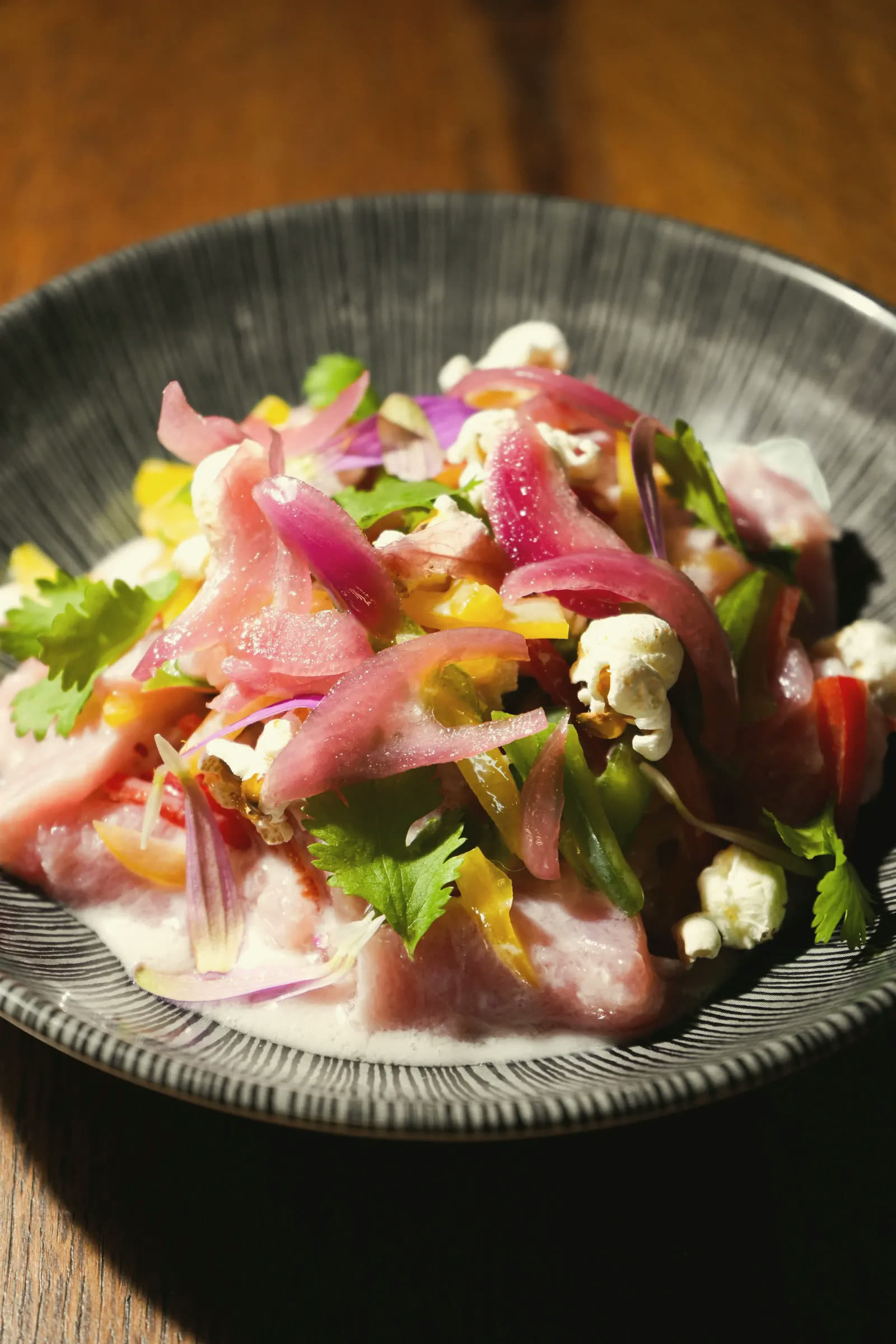 Tuna ceviche with pickled red onion, mango, coriander and popcorn
