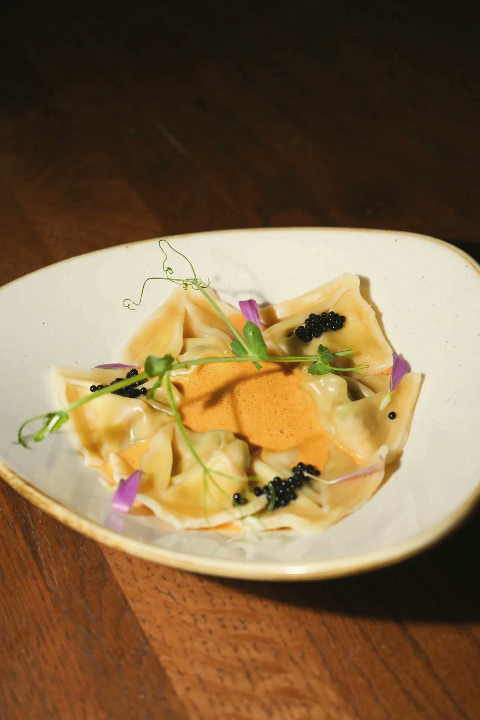 Ravioli with caviar and pea shoots