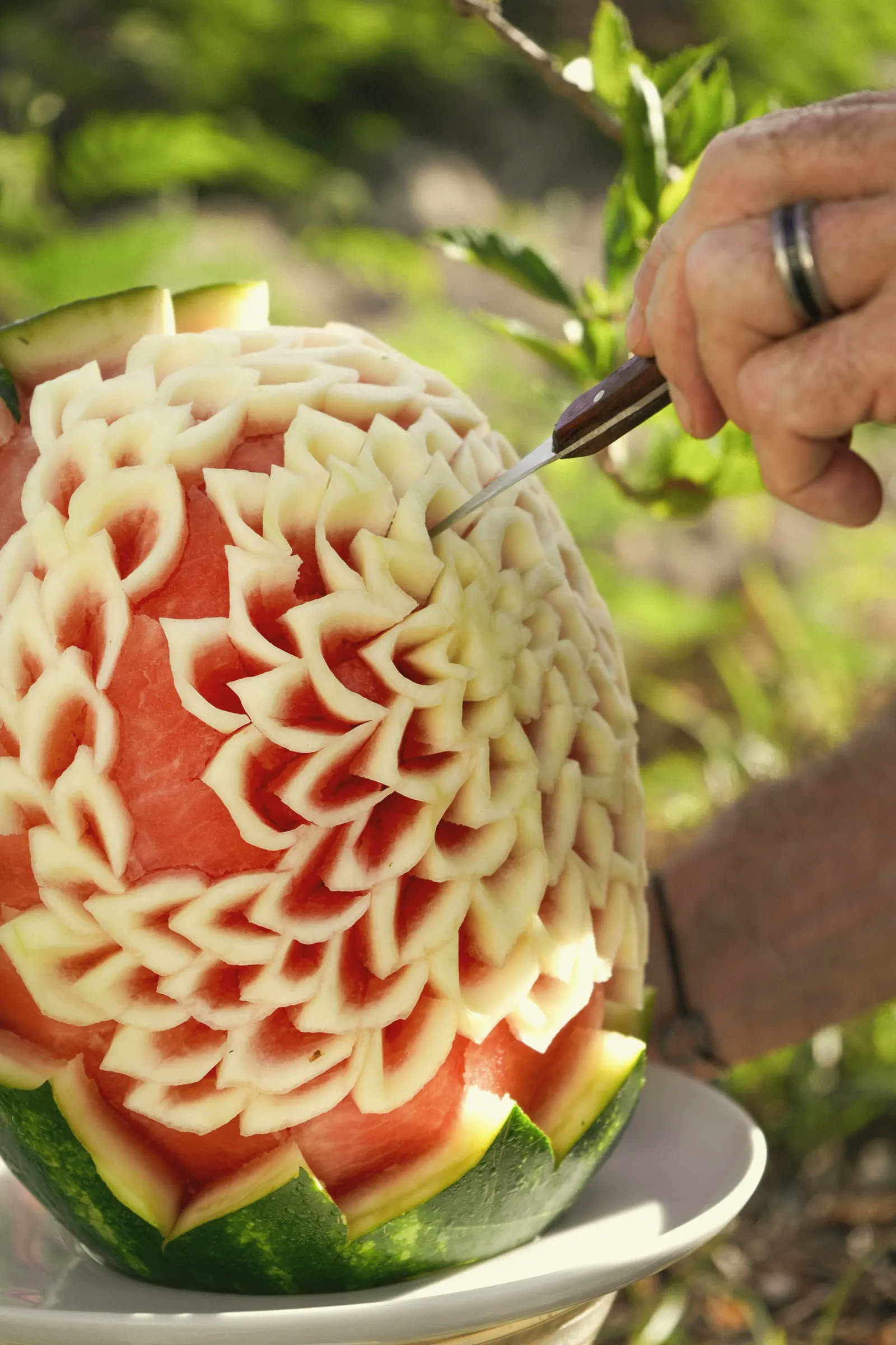 The chef carving a watermelon into a flower